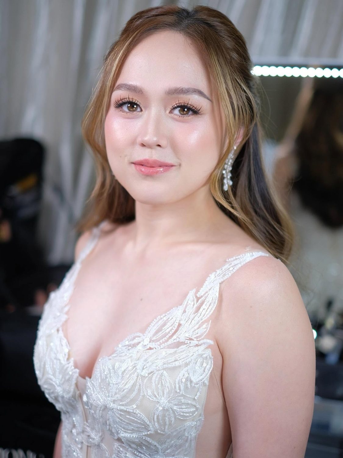 Bride in a lace gown with soft, natural bridal makeup