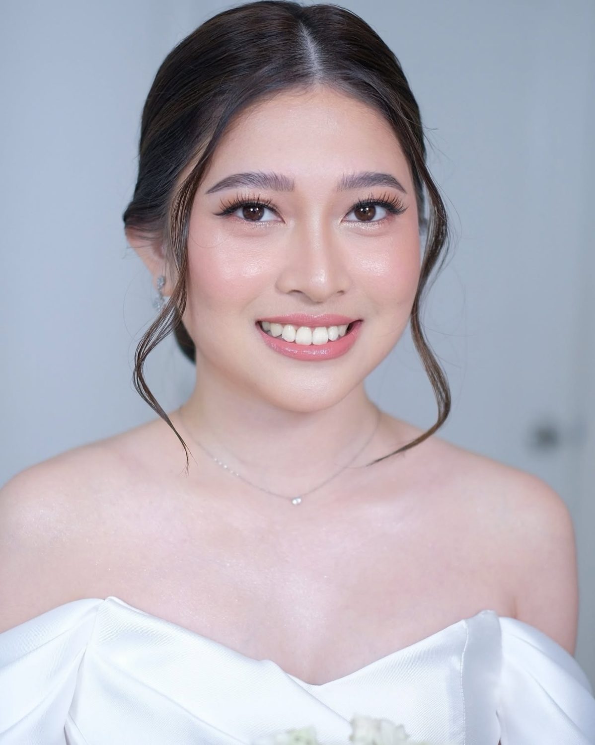 Bride in an off-shoulder gown with glowing skin